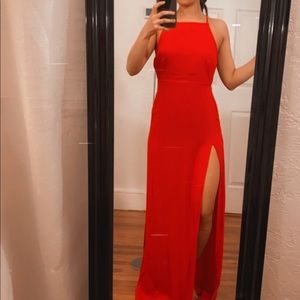 Red strappy dress with slit.